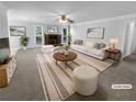 Cozy living room showcasing a stone fireplace, plush furnishings, and bright, natural light at 1720 Winners Cir, Lawrenceville, GA 30043