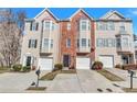Inviting townhome showcasing brick and siding, attached garages, and curb appeal at 2565 Rocky Ct, South Fulton, GA 30349