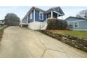 Home exterior featuring a concrete driveway and blue siding with white trim at 318 Kelly Se St, Atlanta, GA 30312