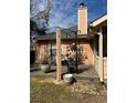 Outdoor patio with decorative metal shade and landscaping at 355 Tait Rd, Stockbridge, GA 30281