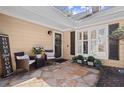 Cozy front porch with seating, décor, and stone paving leading to the front door at 108 Great Oaks Lane, Roswell, GA 30075