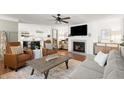 Bright living room with a fireplace, and an open floor plan that connects to the kitchen at 108 Great Oaks Lane, Roswell, GA 30075