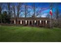 Charming brick home with a manicured lawn and welcoming front porch at twilight at 3250 N Embry Cir, Atlanta, GA 30341