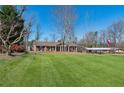 Spacious front yard featuring well-kept lawn, flagpole and brick home with well-maintained landscaping at 3250 N Embry Cir, Atlanta, GA 30341