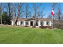 Charming ranch-style home with lush green lawn and manicured landscaping featuring an flagpole in the front yard at 3250 N Embry Cir, Atlanta, GA 30341