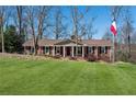 Attractive brick home boasts a well-maintained lawn and an flag pole on a sunny day at 3250 N Embry Cir, Atlanta, GA 30341