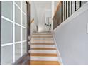Inviting entryway with hardwood stairs and neutral wall colors, leading upstairs at 5341 Concordia Se Pl # 8, Mableton, GA 30126