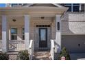 Inviting front porch with columns, brick accents, and stairs leading to the main entrance, number 2300 is visible at 2300 Kate Moore Way, Buford, GA 30518