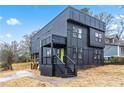 Contemporary black home boasts clean lines, a covered porch, and modern curb appeal at 3139 Alston Dr, Decatur, GA 30032