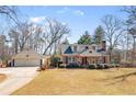 Exterior of home with detached garage; mature trees on a large lot at 7452 Mount Vernon Rd, Lithia Springs, GA 30122