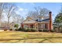 Lovely home features a detached garage, lush yard, and classic brick design at 7452 Mount Vernon Rd, Lithia Springs, GA 30122