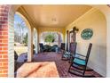 Inviting brick porch with rocking chairs and brick flooring at 7452 Mount Vernon Rd, Lithia Springs, GA 30122