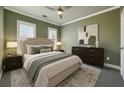 Serene bedroom with soft green walls, neutral bedding, and natural light from shuttered windows at 146 Rowan Ave, Alpharetta, GA 30009
