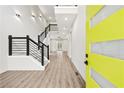 Bright foyer with a modern staircase, light wood floors, and a glimpse of the open-concept living space at 2402 Lynn Iris Dr, Decatur, GA 30032