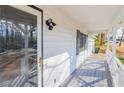 Inviting covered front porch with white railings, offering a cozy entrance to the home and adding to its curb appeal at 3661 Silver Leaf Sw Ln, Marietta, GA 30008