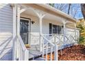 Inviting covered front porch with white railings, offering a cozy entrance to the home and adding to its curb appeal at 3661 Silver Leaf Sw Ln, Marietta, GA 30008