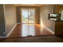 Open dining area featuring hardwood floors and access to an outdoor deck at 4749 Cox Se St, Acworth, GA 30101