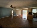 Spacious living room featuring hardwood floors, ceiling fan, and natural light at 4749 Cox Se St, Acworth, GA 30101