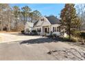 Charming single-story home with white siding, dark shutters, and a welcoming front porch with rocking chairs at 105 Leisure Trl, Peachtree City, GA 30269