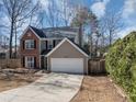 Charming two-story home featuring a brick facade, attached garage, and well-maintained landscaping at 1098 Berkley Se Dr, Smyrna, GA 30082