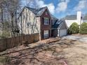 Charming two-story home featuring a brick facade, attached garage, and well-maintained landscaping at 1098 Berkley Se Dr, Smyrna, GA 30082