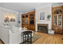 Beautiful living room with hardwood floors, a fireplace, and custom built-ins for storage and display at 1029 Emory Parc Pl, Decatur, GA 30033