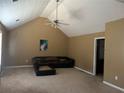 Spacious living room with vaulted ceilings, carpet flooring, and a cozy seating area, perfect for relaxation and entertainment at 1073 Crown Landing Pkwy, Mcdonough, GA 30252