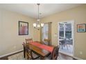 Cozy dining room with hardwood floors, a chandelier, and access to the screened-in porch at 1907 Haven Park Se Cir, Smyrna, GA 30080