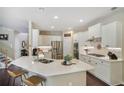 Bright kitchen featuring white cabinetry, stainless steel appliances, and a large island with seating at 1907 Haven Park Se Cir, Smyrna, GA 30080