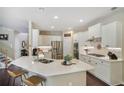 Bright kitchen with white cabinets, stainless steel appliances, quartz countertop, and bar stool seating at 1907 Haven Park Se Cir, Smyrna, GA 30080