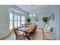 Bright dining room with hardwood floors, a bay window, and modern chandelier at 251 Waterford Cove Dr, Suwanee, GA 30024