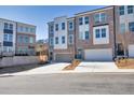 New townhouses showcase two-car garages and brick facade, complemented by a lush, landscaped setting at 399 Skylar Se Way, Atlanta, GA 30315