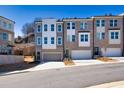 New townhouses showcase two-car garages and brick facade, complemented by a lush, landscaped setting at 399 Skylar Se Way, Atlanta, GA 30315