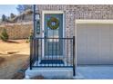 Inviting front door with decorative wreath, house number, and secure entry features at 399 Skylar Se Way, Atlanta, GA 30315