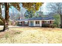 Beautiful brick home with mature trees, blue front door, and well-manicured lawn at 1523 Vancouver Dr, Tucker, GA 30084