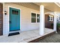Close-up of the front porch showing a blue door and brick details at 1523 Vancouver Dr, Tucker, GA 30084