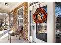 Inviting front porch with stone accents, chairs, and a decorative wreath on the front door at 599 Jefferson Chase St, Atlanta, GA 30354