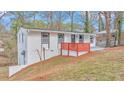 Charming renovated house with red railing on front porch and professionally landscaped yard at 125 Glenrose Sw Cir, Atlanta, GA 30354