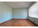 Living room with light blue walls, hardwood floors, and a bright window at 1879 Mural Cir, Morrow, GA 30260