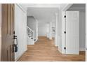 Bright foyer with hardwood floors and elegant white trim, leading to the main living area at 6951 Foxmoor Way, Douglasville, GA 30134