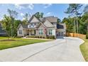 Charming two-story home with a long driveway and a combination of stone and brick accents at 783 Phil Haven Ln, Kennesaw, GA 30152