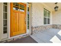 Close-up of a solid wood front door with sidelights and stylish exterior lighting at 783 Phil Haven Ln, Kennesaw, GA 30152