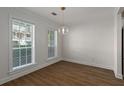 Bright dining room with wood floors, natural light, and contemporary light fixture at 1004 Masons Creek Cir # 1004, Atlanta, GA 30350