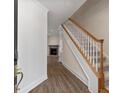 Inviting entryway featuring wood-look floors, stairs to upper level, and adjacent living space at 1004 Masons Creek Cir # 1004, Atlanta, GA 30350