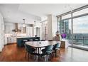 Dining area and kitchen featuring floor-to-ceiling windows with great views and modern lighting at 1065 Peachtree Ne St # 3005, Atlanta, GA 30309