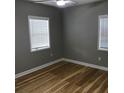 A cozy bedroom featuring hardwood floors and natural light from large windows at 1140 Smith Sw St, Atlanta, GA 30310