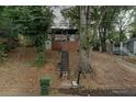 Charming home featuring a covered porch and an inviting entrance with a staircase at 1140 Smith Sw St, Atlanta, GA 30310