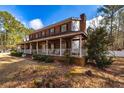Brick home with a huge wrap around porch and white railings, offering a serene outdoor space at 150 Hillred Dr, Fayetteville, GA 30215