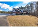 Spacious brick home boasts an attached garage and a well-maintained lawn, perfect for Gathering living at 150 Hillred Dr, Fayetteville, GA 30215