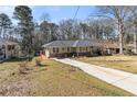 Attractive one-story house with a long drive way, featuring beautiful yard at 2100 Shady Ln, Tucker, GA 30084